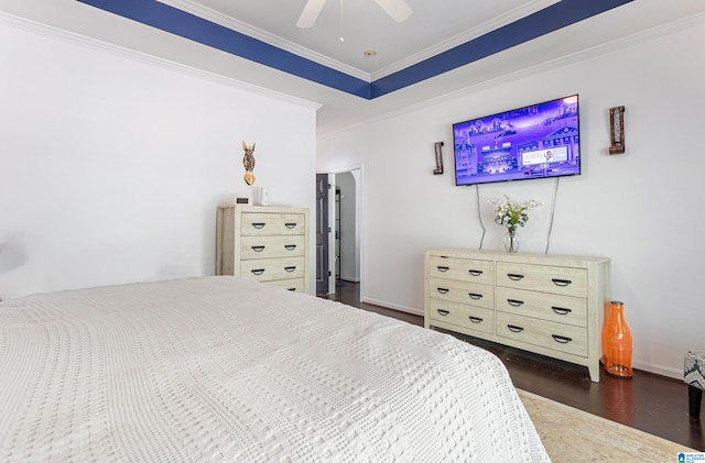 bedroom with ceiling fan, dark hardwood / wood-style floors, and ornamental molding