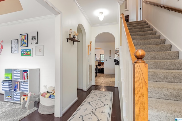 interior space with ornamental molding and hardwood / wood-style floors