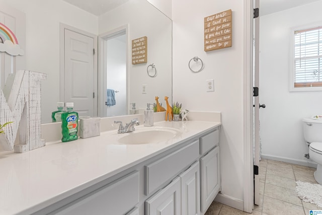 bathroom with tile patterned flooring, vanity, and toilet