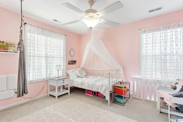 bedroom with ceiling fan and light carpet