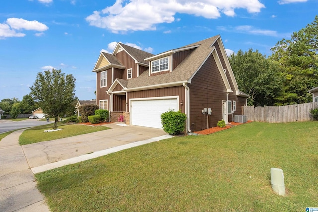 view of front of house featuring a garage, a front yard, and cooling unit