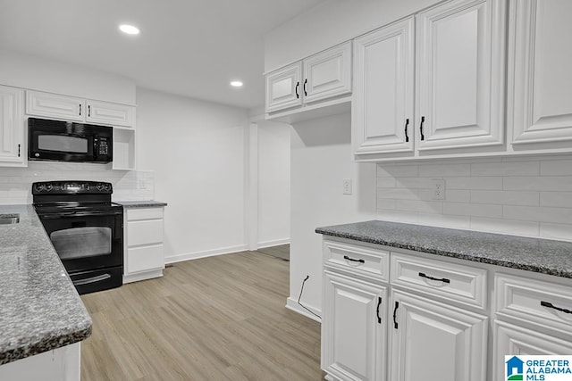 kitchen with light wood-type flooring, dark stone counters, tasteful backsplash, black appliances, and white cabinets