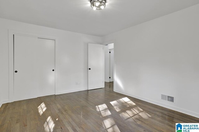 2604 Wood Dr NE, Center Point, AL 35215 - unfurnished bedroom featuring visible vents, a closet, baseboards, and wood finished floors