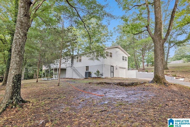 view of home's exterior with a garage and central AC unit