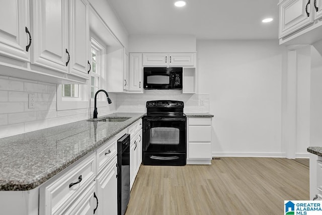2604 Wood Dr NE, Center Point, AL 35215 - kitchen with light wood finished floors, black appliances, a sink, and white cabinets