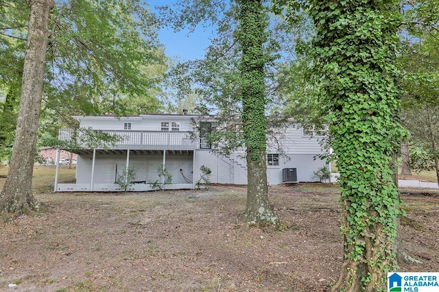 back of house featuring a wooden deck and central AC unit