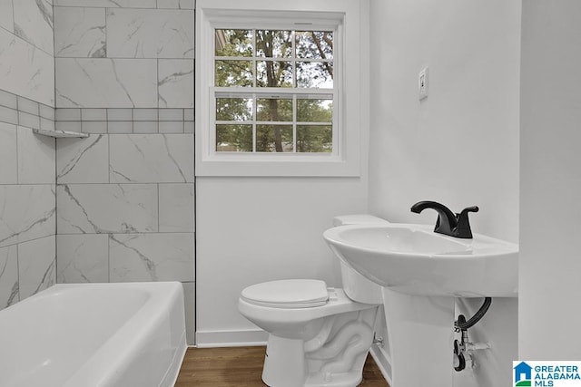 2604 Wood Dr NE, Center Point, AL 35215 - bathroom with toilet, tub / shower combination, and wood finished floors