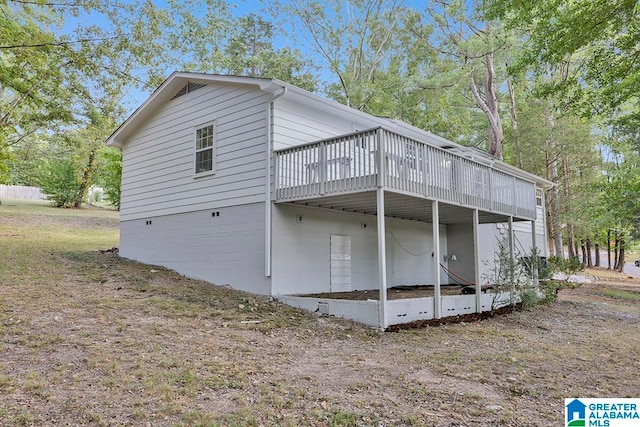 view of property exterior featuring a wooden deck