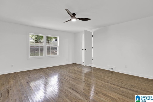 empty room featuring ceiling fan and dark hardwood / wood-style flooring