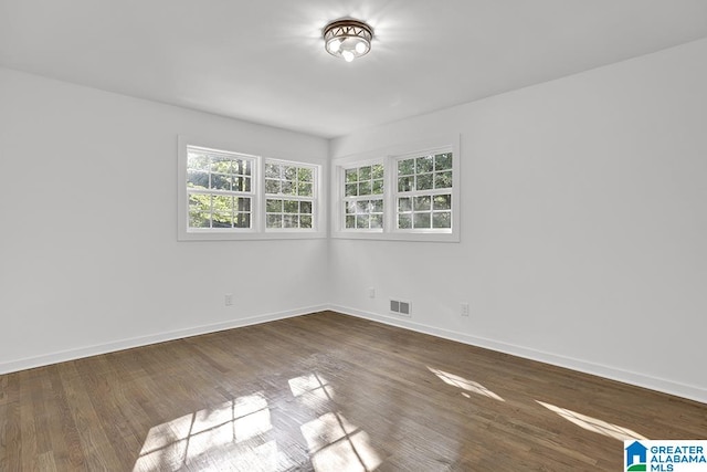 unfurnished room featuring dark hardwood / wood-style flooring