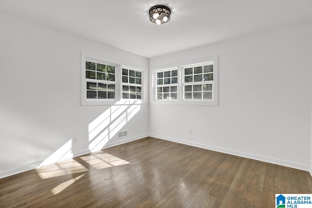 empty room with dark wood-type flooring