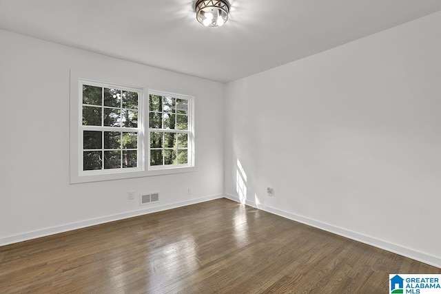 unfurnished room featuring dark wood-type flooring