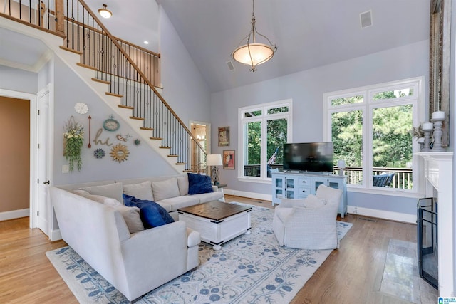 living room featuring high vaulted ceiling and hardwood / wood-style flooring