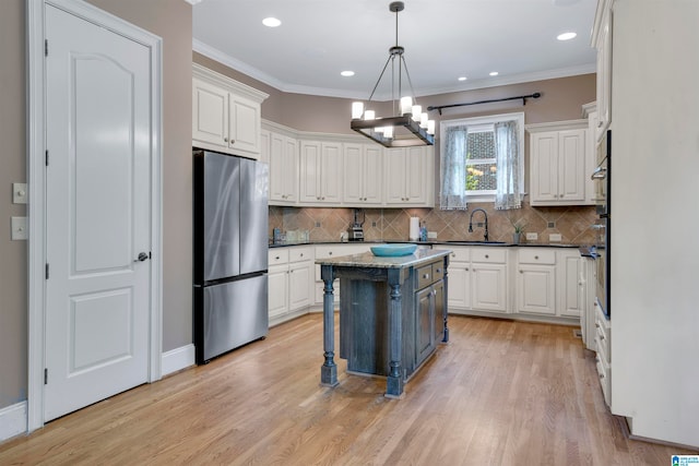 kitchen featuring a center island, appliances with stainless steel finishes, and white cabinets