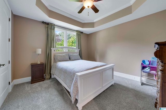 bedroom featuring carpet flooring, ceiling fan, a raised ceiling, and crown molding