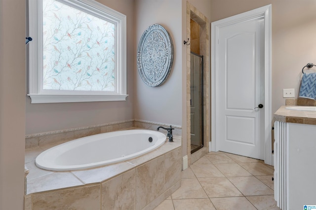 bathroom featuring vanity, a wealth of natural light, independent shower and bath, and tile patterned flooring