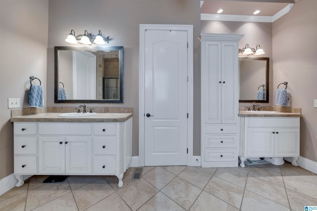 bathroom with crown molding and vanity