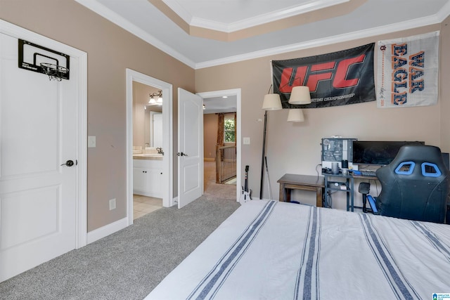 bedroom featuring light colored carpet, a raised ceiling, ensuite bathroom, and ornamental molding