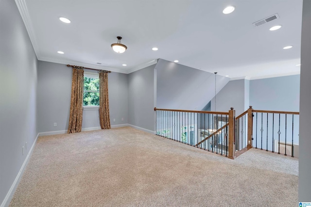 spare room featuring lofted ceiling, carpet, and ornamental molding