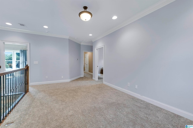 spare room with light colored carpet and ornamental molding