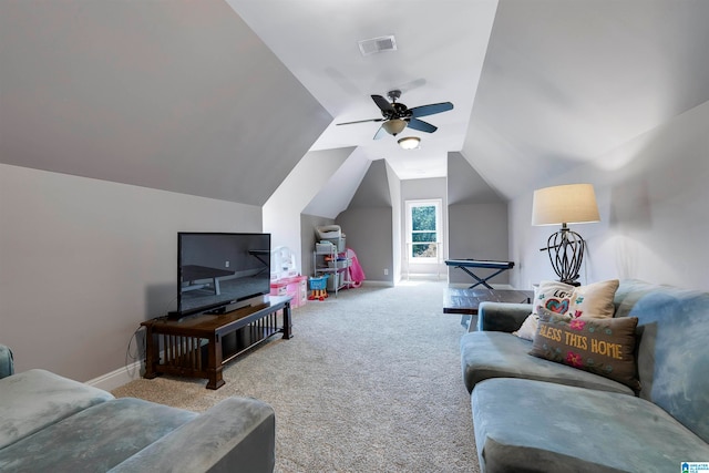 living room with lofted ceiling, ceiling fan, and carpet