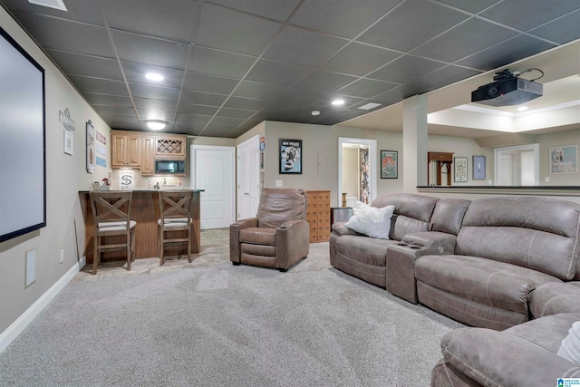 interior space featuring light colored carpet and a paneled ceiling