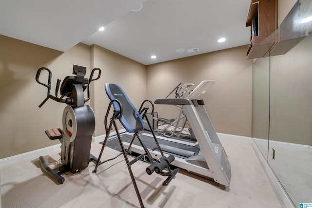 workout room featuring light colored carpet