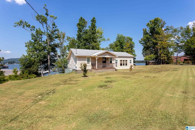 exterior space featuring a water view, a porch, and a yard