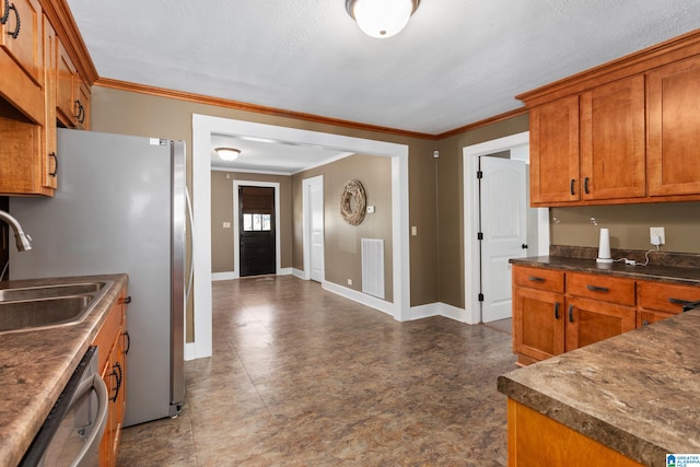 kitchen with dishwasher, a textured ceiling, tile patterned floors, sink, and ornamental molding