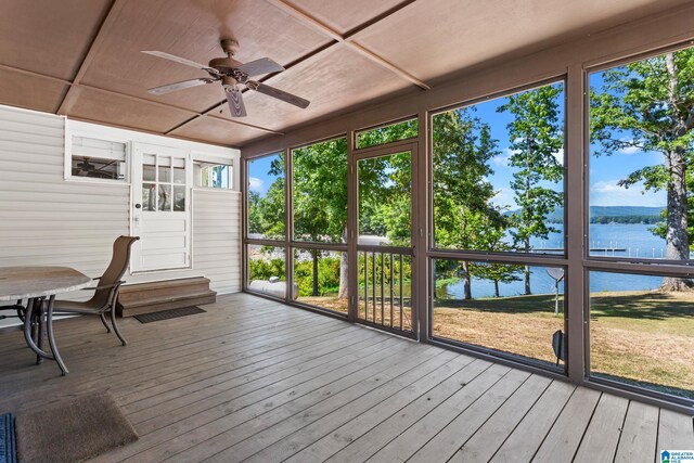 wooden deck featuring ceiling fan and a water view