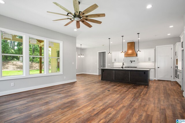 interior space featuring a wealth of natural light, dark wood-type flooring, and a notable chandelier