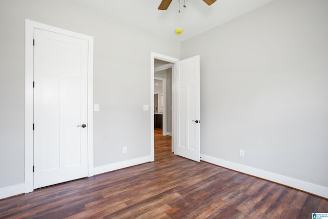 unfurnished bedroom with ceiling fan and dark hardwood / wood-style floors