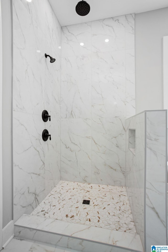 bathroom with tiled shower