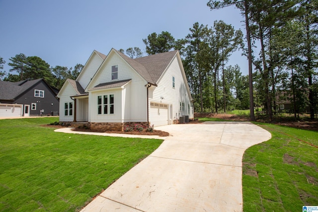 view of side of property with a garage and a lawn