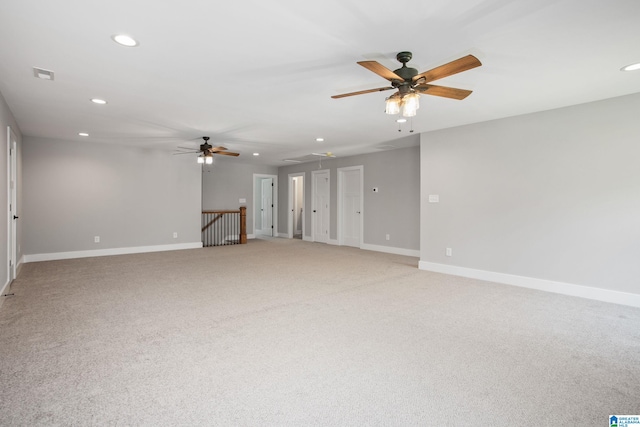 unfurnished living room featuring light colored carpet and ceiling fan