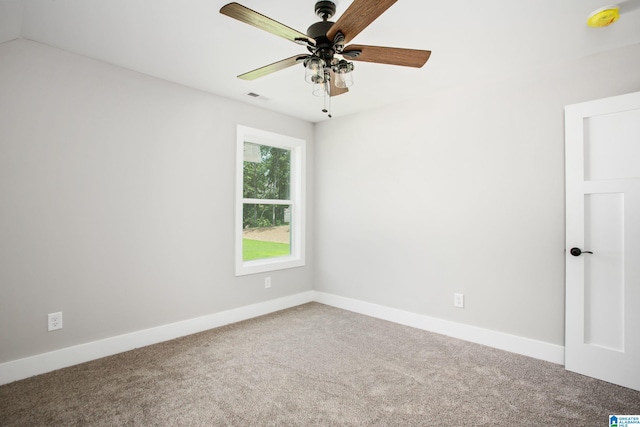 carpeted spare room with ceiling fan