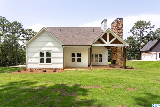 back of house with a patio area and a yard