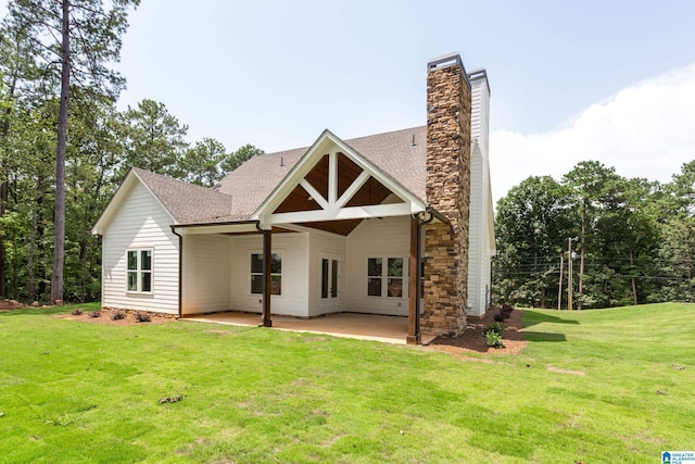 view of front of house with a patio and a front lawn