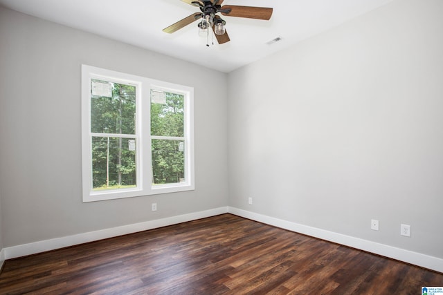 spare room featuring ceiling fan and dark hardwood / wood-style floors