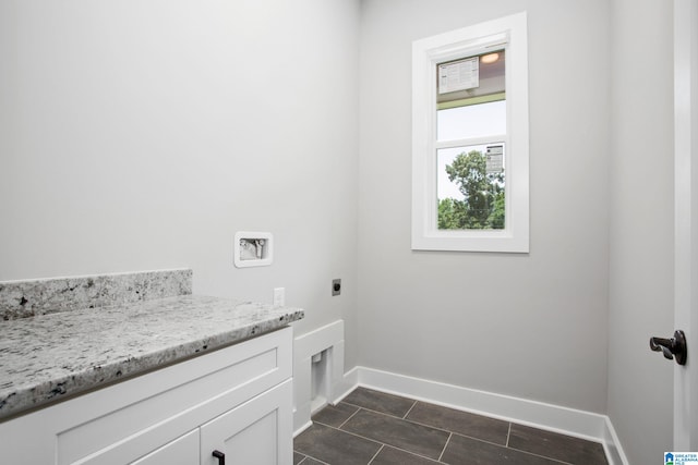 laundry area featuring washer hookup, electric dryer hookup, and cabinets