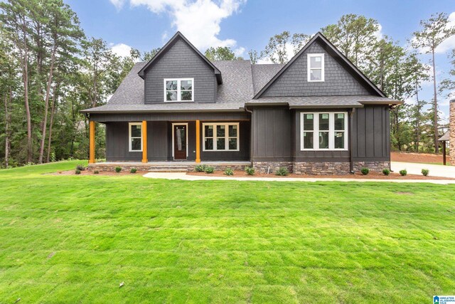 view of front facade with a front yard and a porch