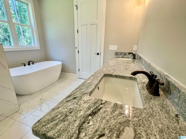 bathroom with a tub to relax in and vanity