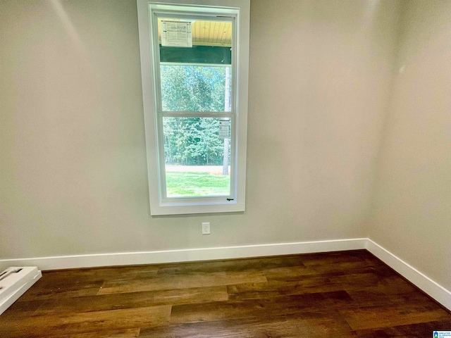 spare room featuring dark hardwood / wood-style flooring