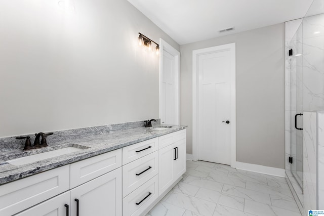 full bathroom featuring marble finish floor, visible vents, a sink, and double vanity