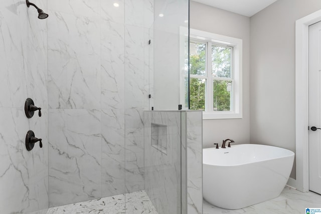 bathroom featuring marble finish floor, a soaking tub, and a marble finish shower