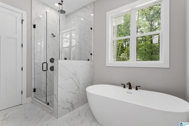 full bathroom with marble finish floor, a marble finish shower, and a freestanding bath