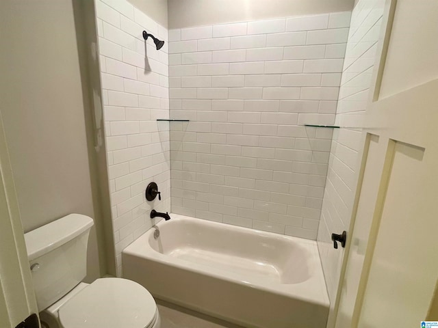 bathroom featuring tiled shower / bath and toilet