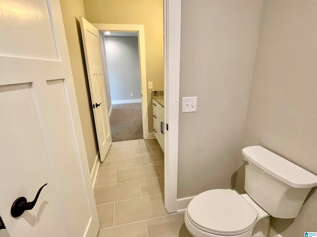 bathroom featuring tile patterned flooring, vanity, and toilet