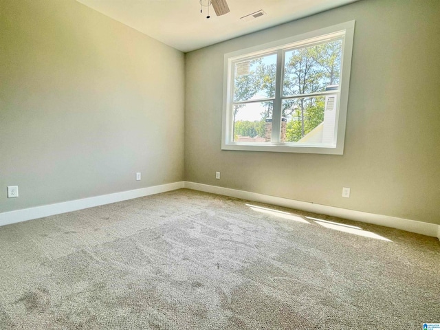 carpeted empty room featuring ceiling fan