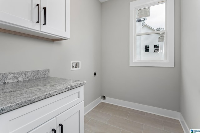 clothes washing area featuring light tile patterned floors, hookup for a washing machine, cabinet space, hookup for an electric dryer, and baseboards